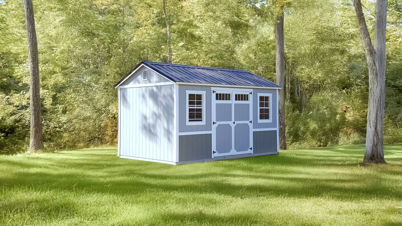 Two-tone gray utility shed with double doors and transom windows on a lawn, showing the standard A-Frame build