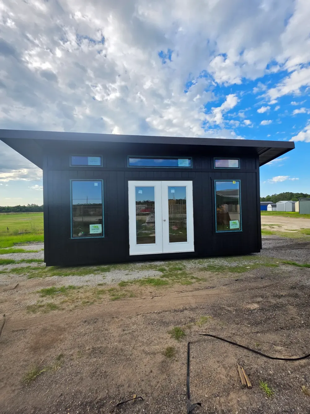 Premium Series Modern Studio with black trim, French doors and a single-slope metal roof